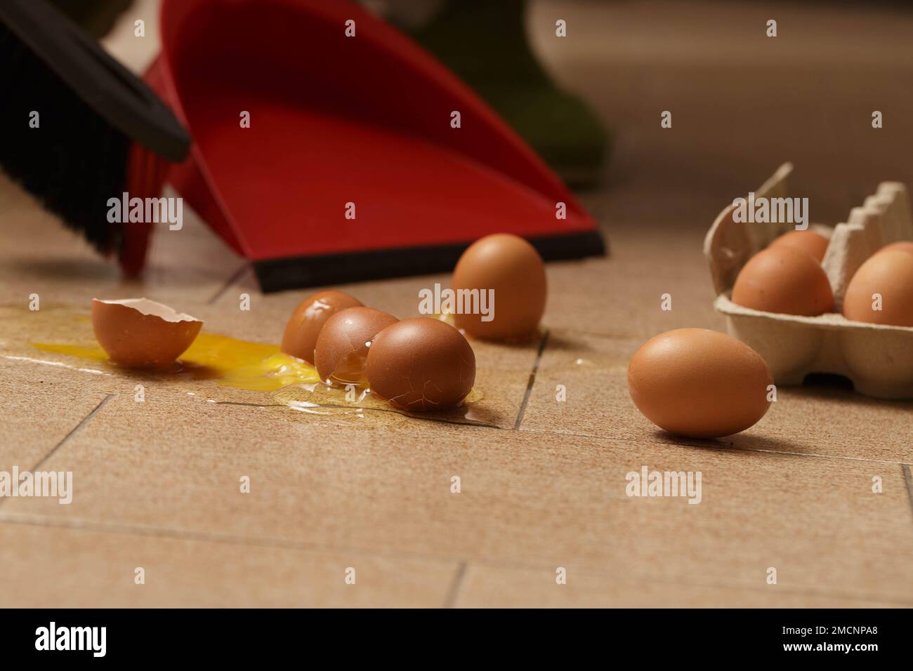 Cracked Eggs Macro Image: Yolk Spilled on the Floor Stock Photo