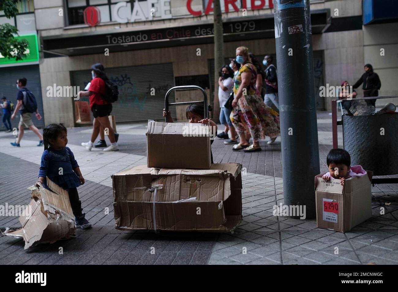 Children play with cardboard boxes on one of the streets of downtown