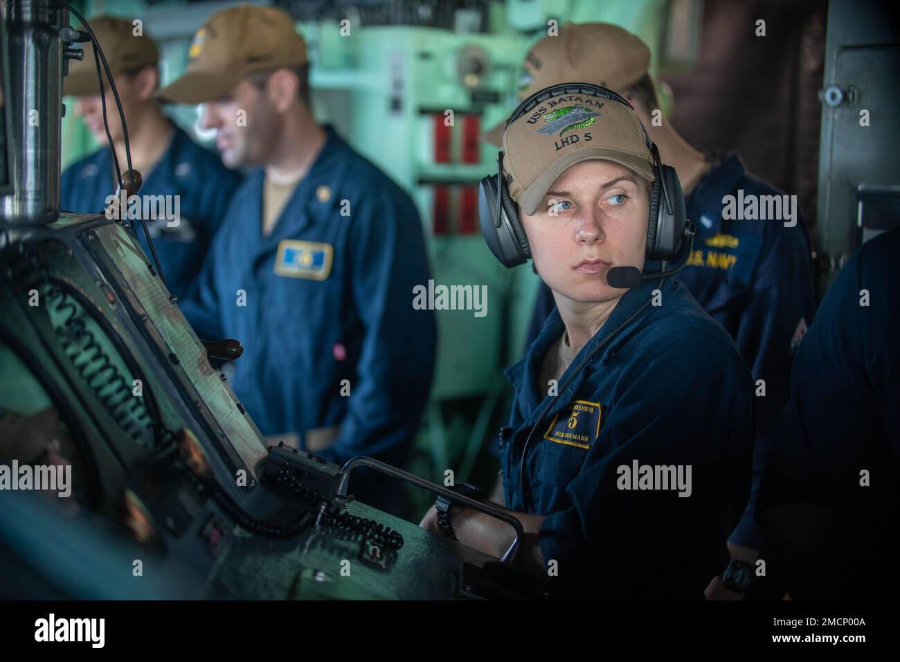 220830-N-OM737-0028  ATLANTIC OCEAN (August 30, 2022) Ensign Nicole Oehlmann, assigned to the Wasp-class amphibious assault ship USS Bataan (LHD 5) Operations Department, conducts bridge operations on the ship’s bridge during a replenishment-at-sea, Aug. 30, 2022. Bataan is underway conducting an Afloat Training Group engineering inspection as part of the basic phase training cycle. Stock Photo