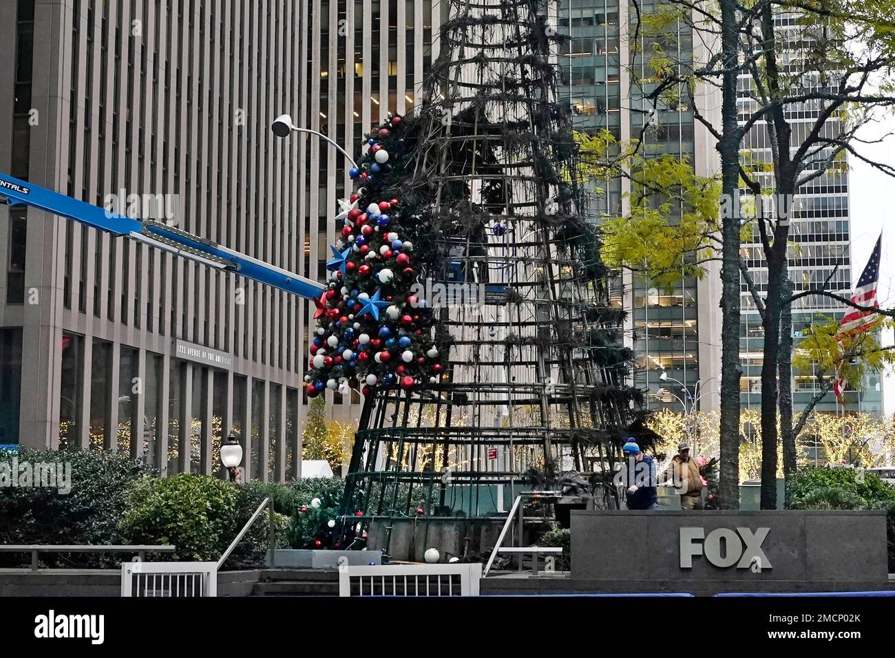 Workers disassemble a Christmas tree outside Fox News headquarters, in