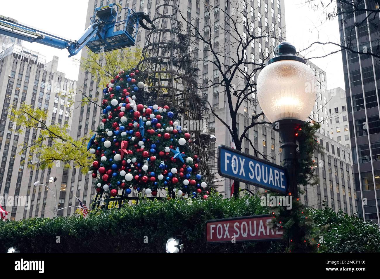 A worker disassembles a Christmas tree outside Fox News headquarters