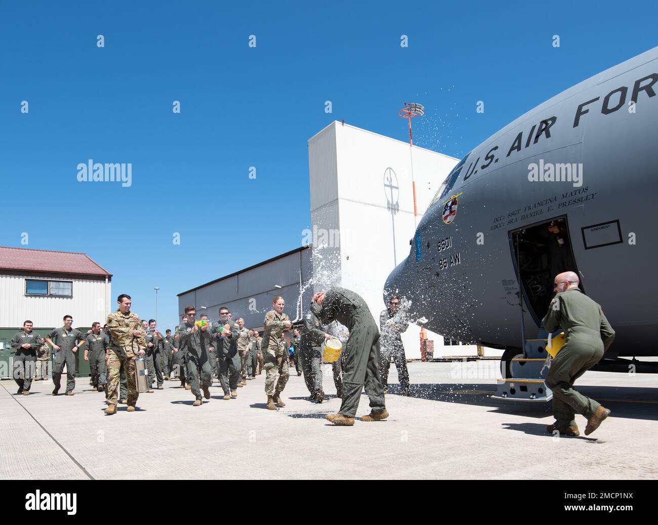 U.S. Air Force Brig. Gen. Joshua M. Olson, 86th Airlift Wing commander, is greeted by members of Team Ramstein at Ramstein Air Base, Germany, July 8, 2022. A final flight, or fini-flight, is a USAF tradition to celebrate one's last flight with their unit which includes spraying champagne or water on the Airman, making a toast, and dowsing water from a fire truck onto the aircraft and aircrew. Stock Photo