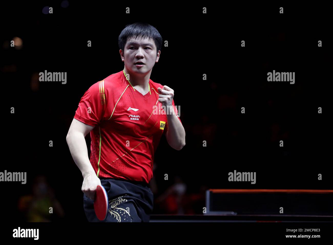 China's Fan Zhendong reacts to winning a point against Japan's Tomokazu