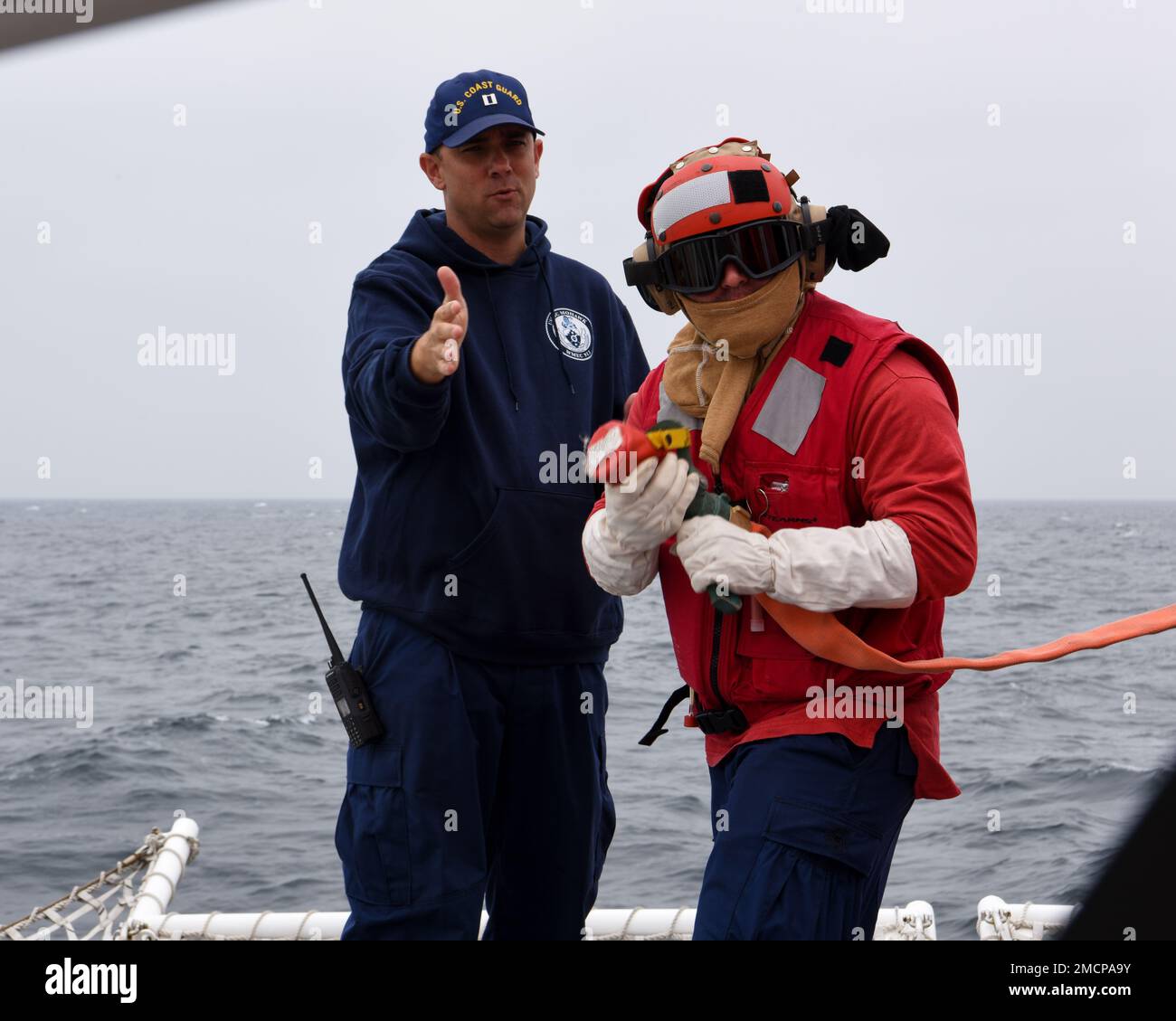 U.S. Coast Guard Lt. Justin Johnson, left, engineering officer of the ...