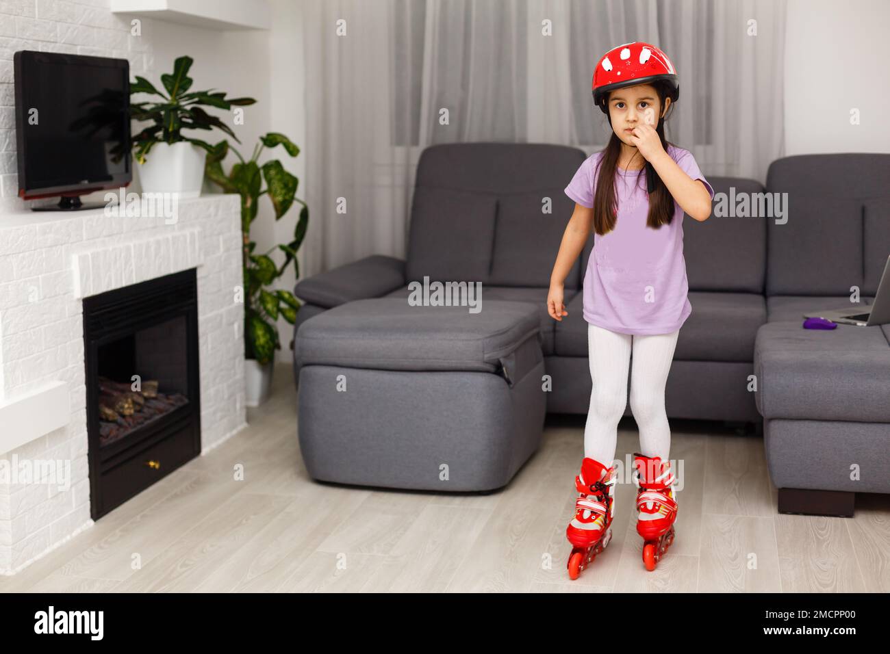 little girl is roller skating at home Stock Photo Alamy