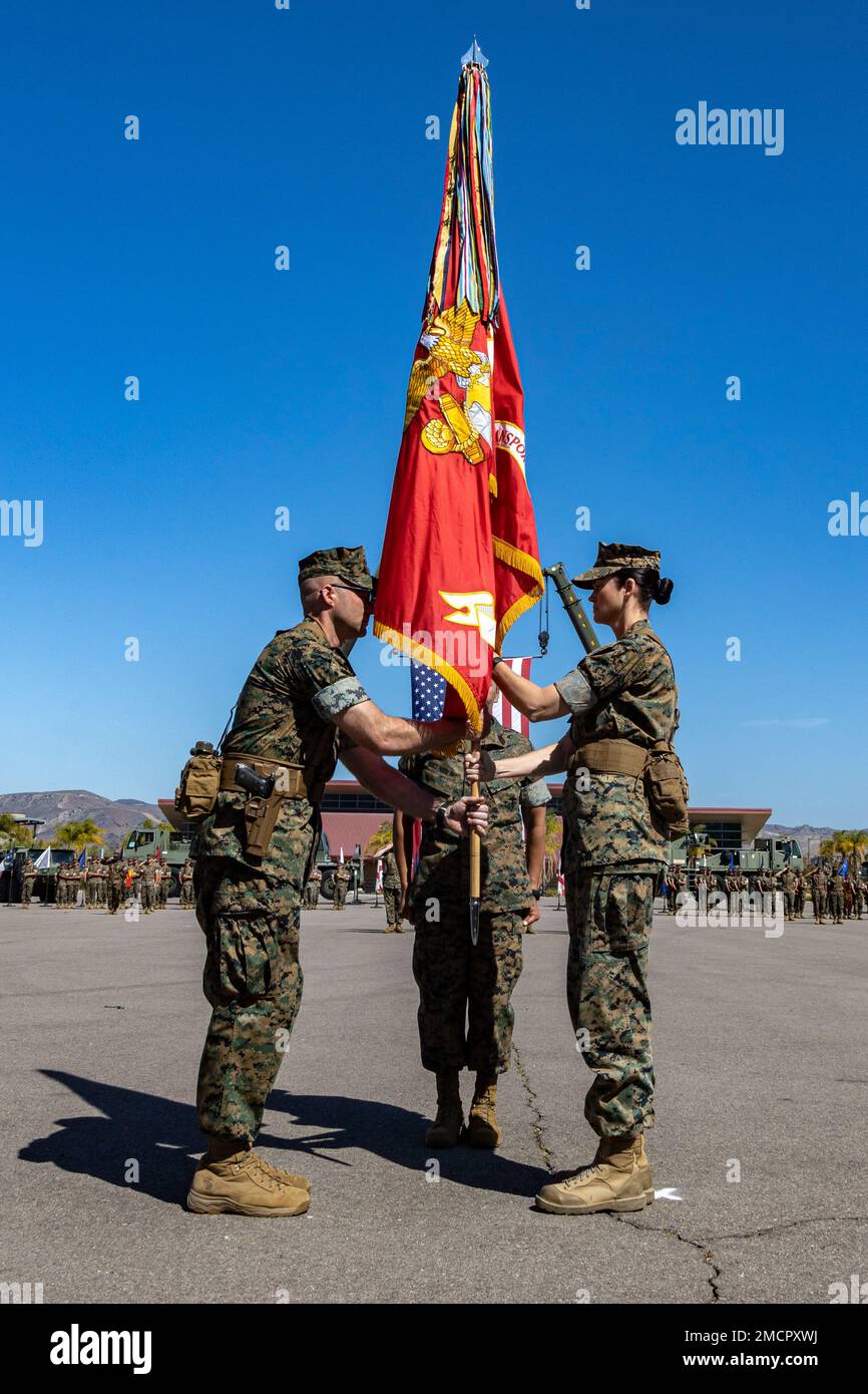 U.S. Marine Corps Lt. Col. Carrie Stocker, right, the off-going commander of 1st Transportation Battalion, Combat Logistics Regiment 1, 1st Marine Logistics Group, passes the unit colors to Lt. Col. Andrew Harkins during a change of command ceremony on Camp Pendleton, California, July 8, 2022. The 1st Transportation Battalion change of command ceremony marked the passing of command from Lt. Col. Carrie E. Stocker to Lt. Col. Andrew S. Harkins. Stock Photo