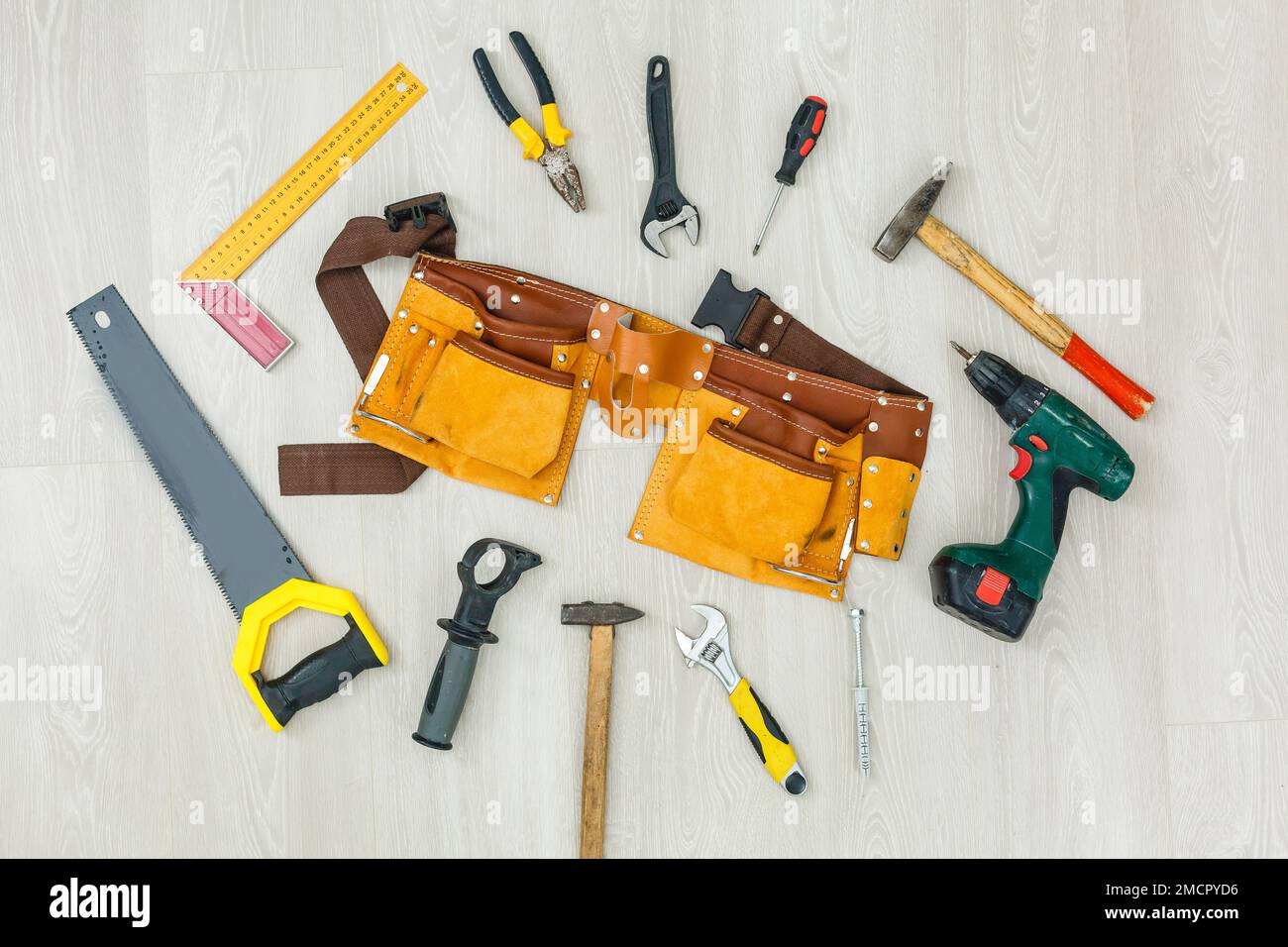 Engineered wooden flooring installation. Grey flooring with foam