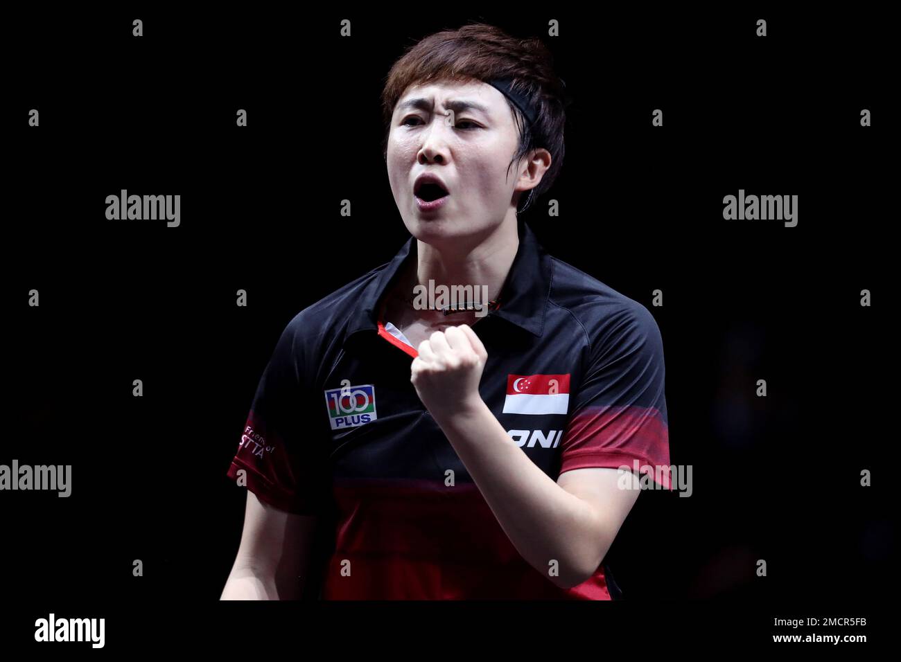 Singapore's Feng Tianwei reacts to winning a point against South Korea