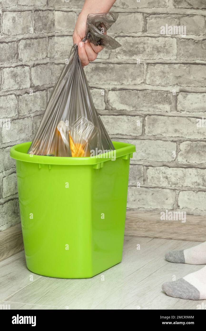 man throws out a garbage bag with waste. waste bag. trash can Stock