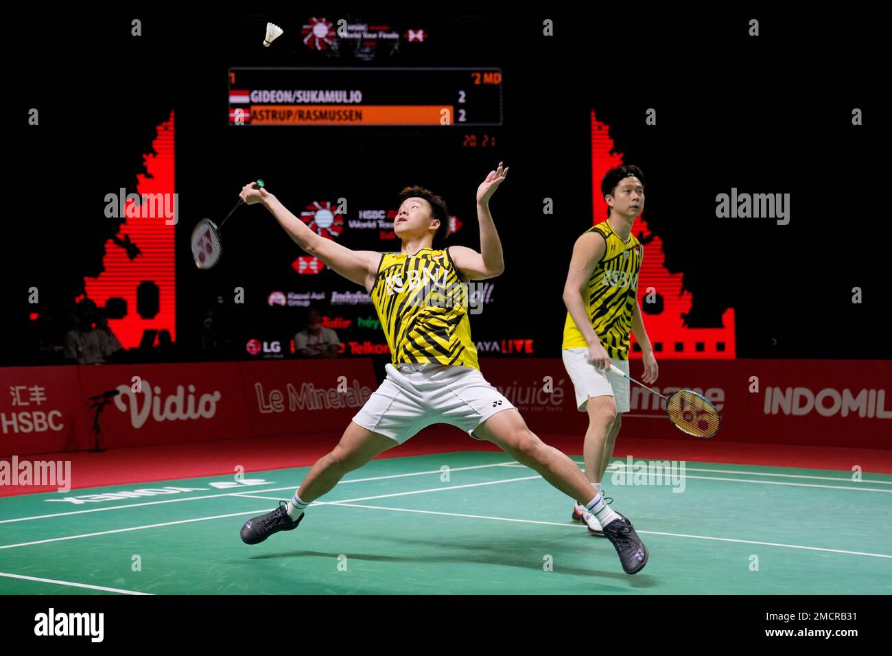Indonesias Marcus Fernaldi Gideon, left, and Kevin Sanjaya Sukamuljo compete against Denmarks Kim Astrup and Anders Skaarup Rasmussen during their mens doubles badminton group stage match at the BWF World Tour Finals