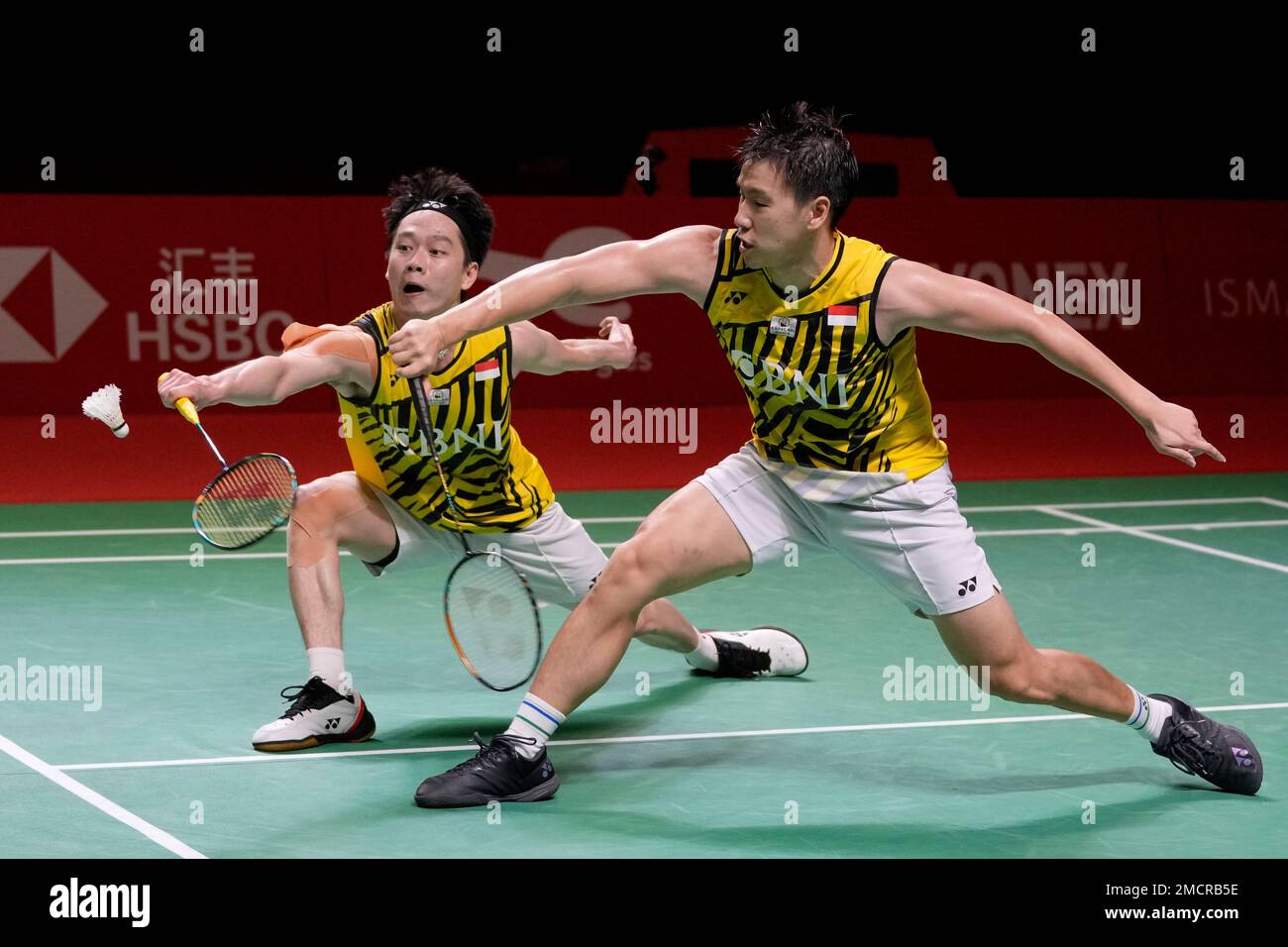 Indonesias Marcus Fernaldi Gideon, right, and Kevin Sanjaya Sukamuljo compete against Denmarks Kim Astrup and Anders Skaarup Rasmussen during their mens doubles badminton group stage match at the BWF World Tour Finals