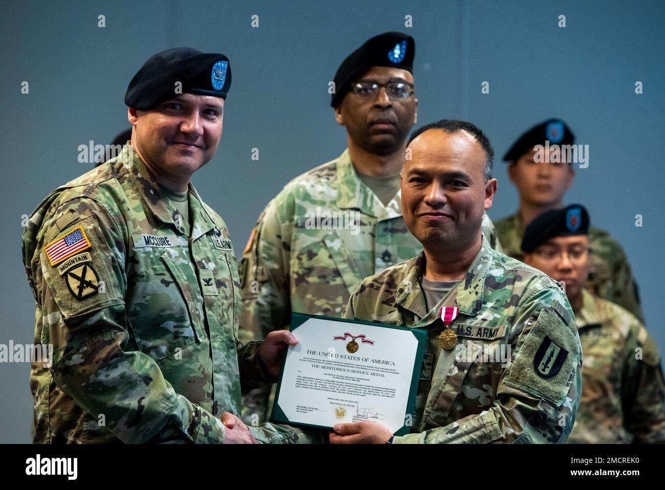 U.S Army Col. Chirstopher S. McClure, 1st Theater Signal Brigade Commander and Lt. Col. Sirian Thepsoumane holing the U.S. Army Meritorious Service Medal award at the 1st Theater Signal Brigade Headquarters in Camp Humphreys, South Korea on July 8, 2022. Thepsoumane was recognized for his services as the United States Army Communications Information Systems Activity Pacific Director. Stock Photo