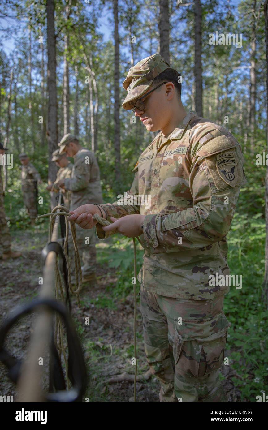 Staff Sgt. Adan Sanches, 11th Airborne Division, pratices tying a ...