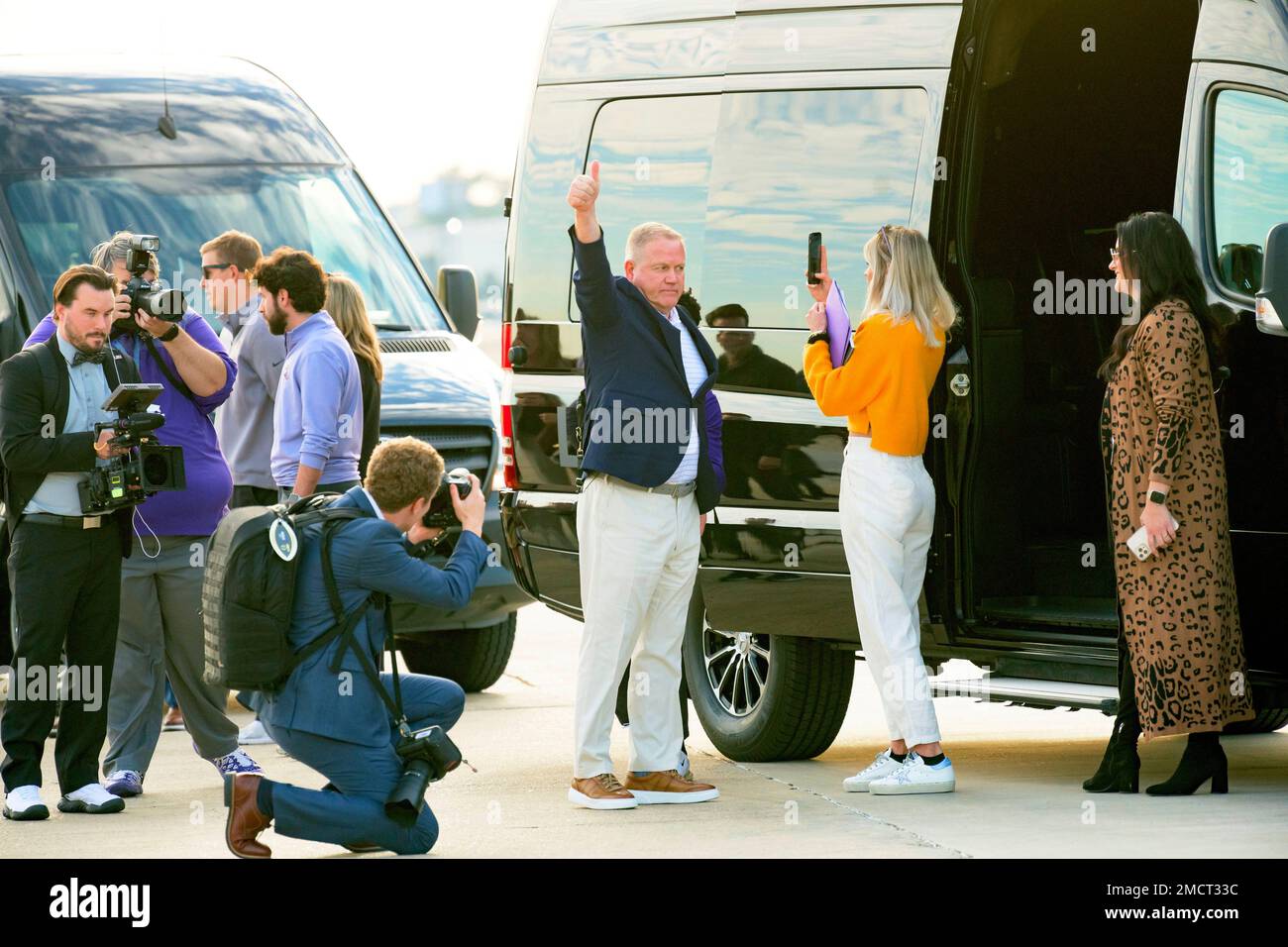 New LSU football coach Brian Kelly gestures to fans after his arrival at Baton Rouge Metropolitan Airport, Tuesday, Nov. 30, 2021, in Baton Rouge, La. Kelly, formerly of Notre Dame, is said