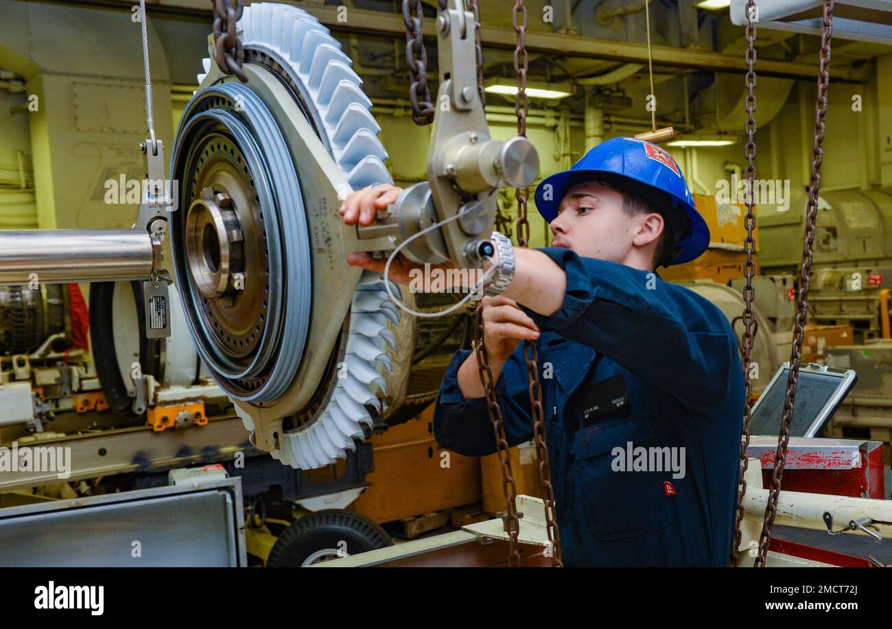 220709-N-FB730-1097 IONIAN SEA (July 9, 2022) Airman Sterling Gibbs, from Phoenix, installs a high powered turbine onto a jet engine in the jet shop aboard the USS Harry S. Truman (CVN 75), July 9, 2022. The Harry S. Truman Carrier Strike Group is on a scheduled deployment in the U.S. Naval Forces Europe area of operations, employed by U.S. Sixth Fleet to defend U.S., allied and partner interests. Stock Photo