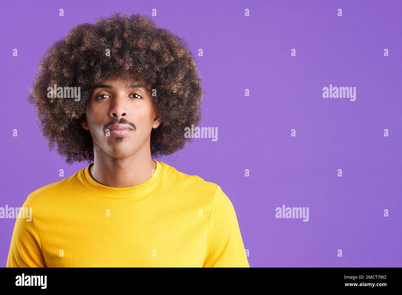 African man looking at the camera with a serious look Stock Photo