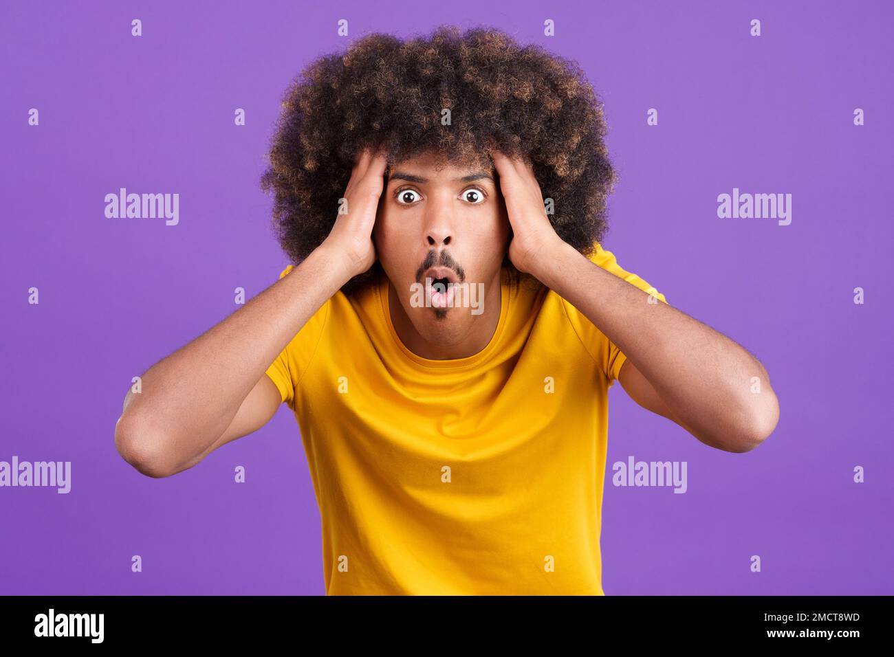 Surprised african man looking at the camera gesturing Stock Photo