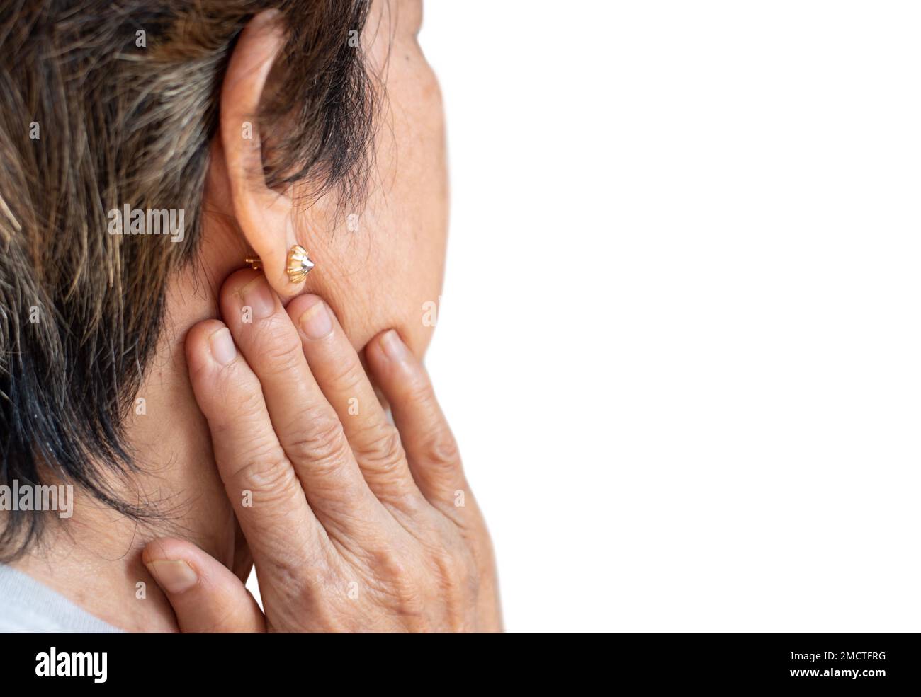 Pain behind the ear of Asian female patient. She feels earache and lymph node pain. Stock Photo