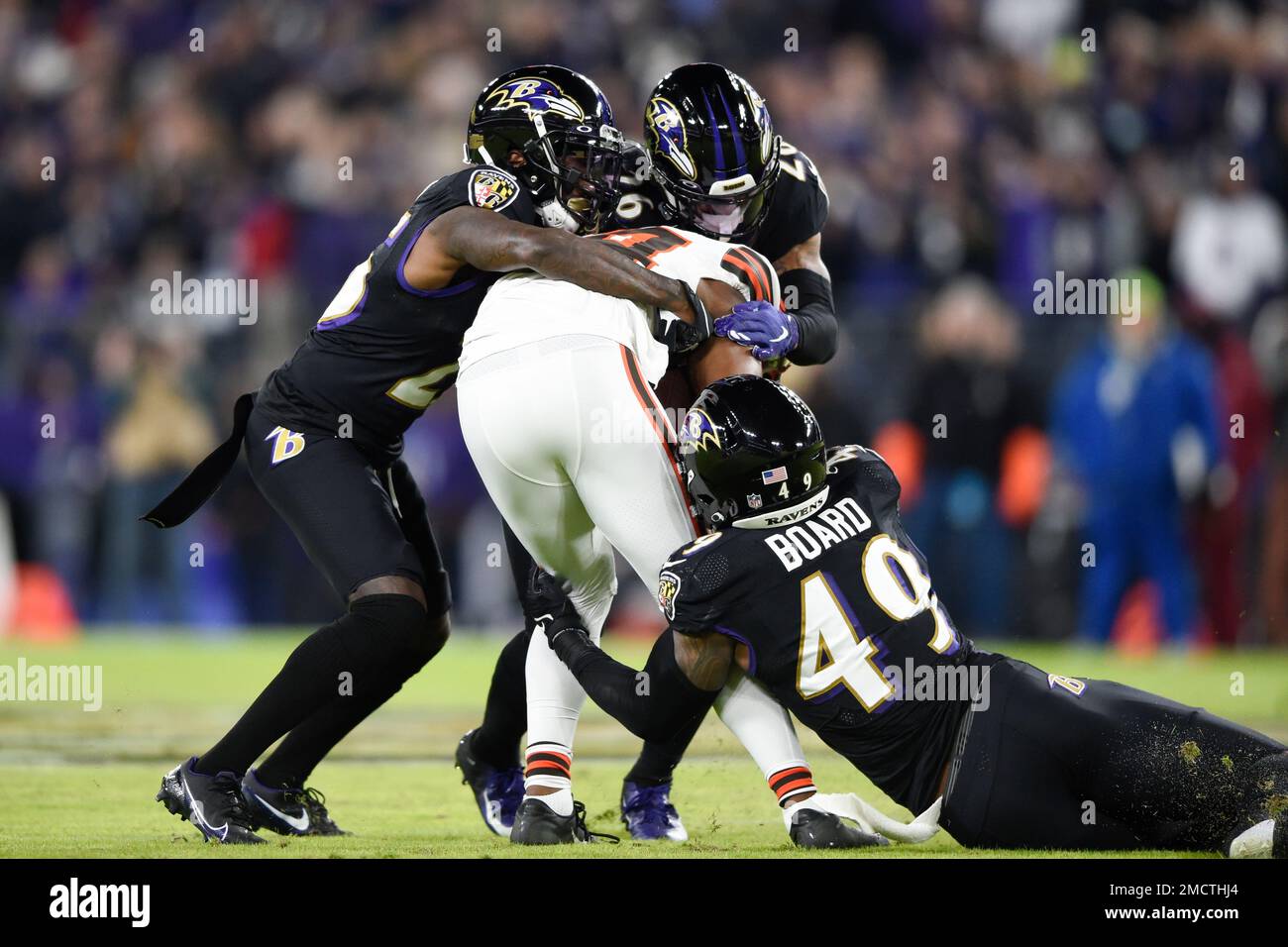 Cleveland Browns wide receiver Ja'Marcus Bradley, center, is tackled by  Baltimore Ravens cornerback Tavon Young, left, safety Geno Stone, right,  and linebacker Chris Board, bottom, during the second half of an NFL