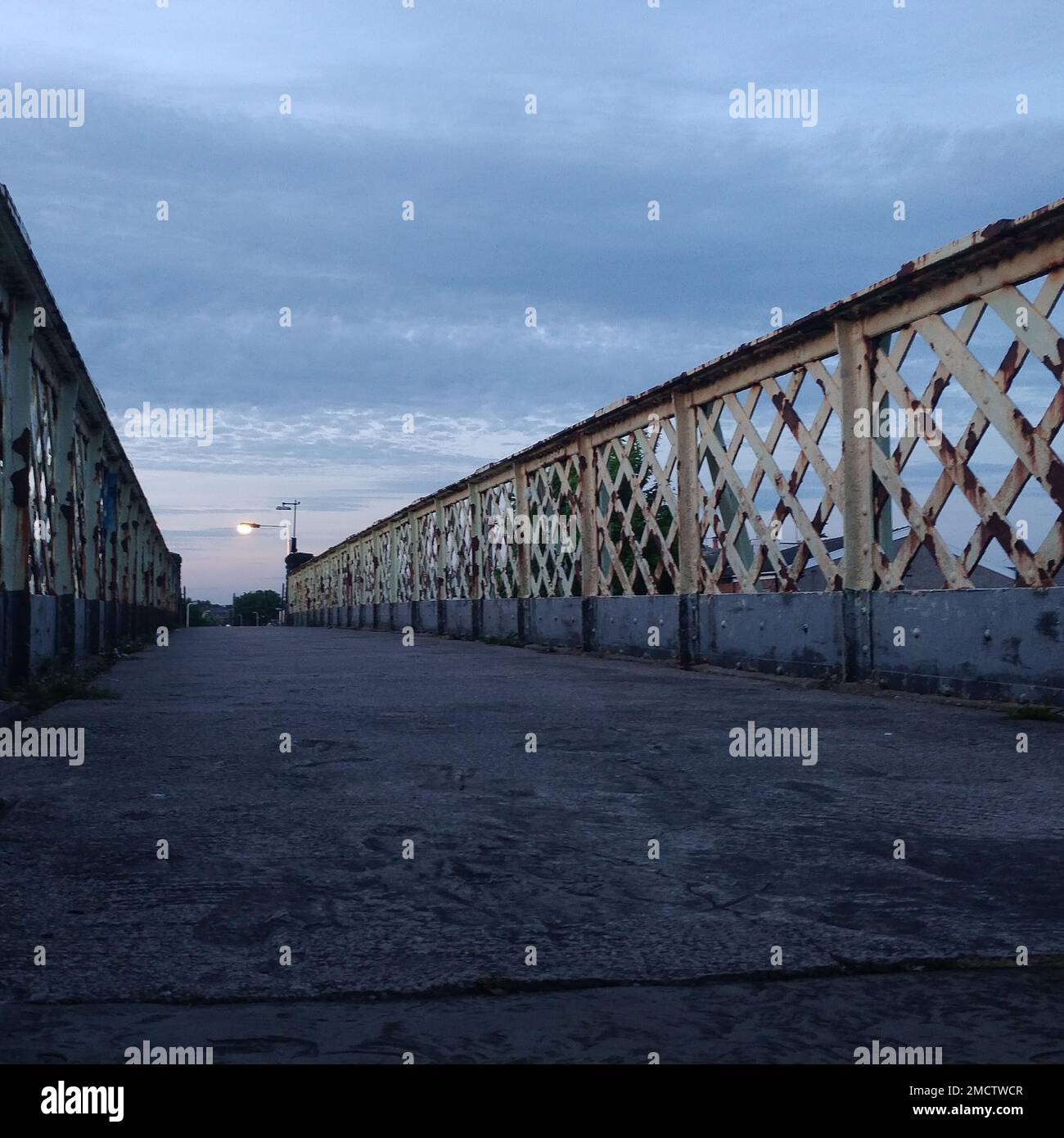 An empty old and rustic bridge under a cloudy sky Stock Photo - Alamy