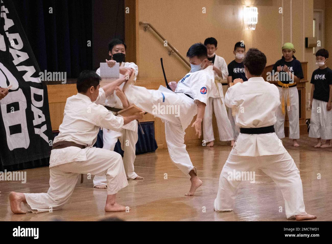 A martial artist kicks a board during Japan Day at Misawa Air Base