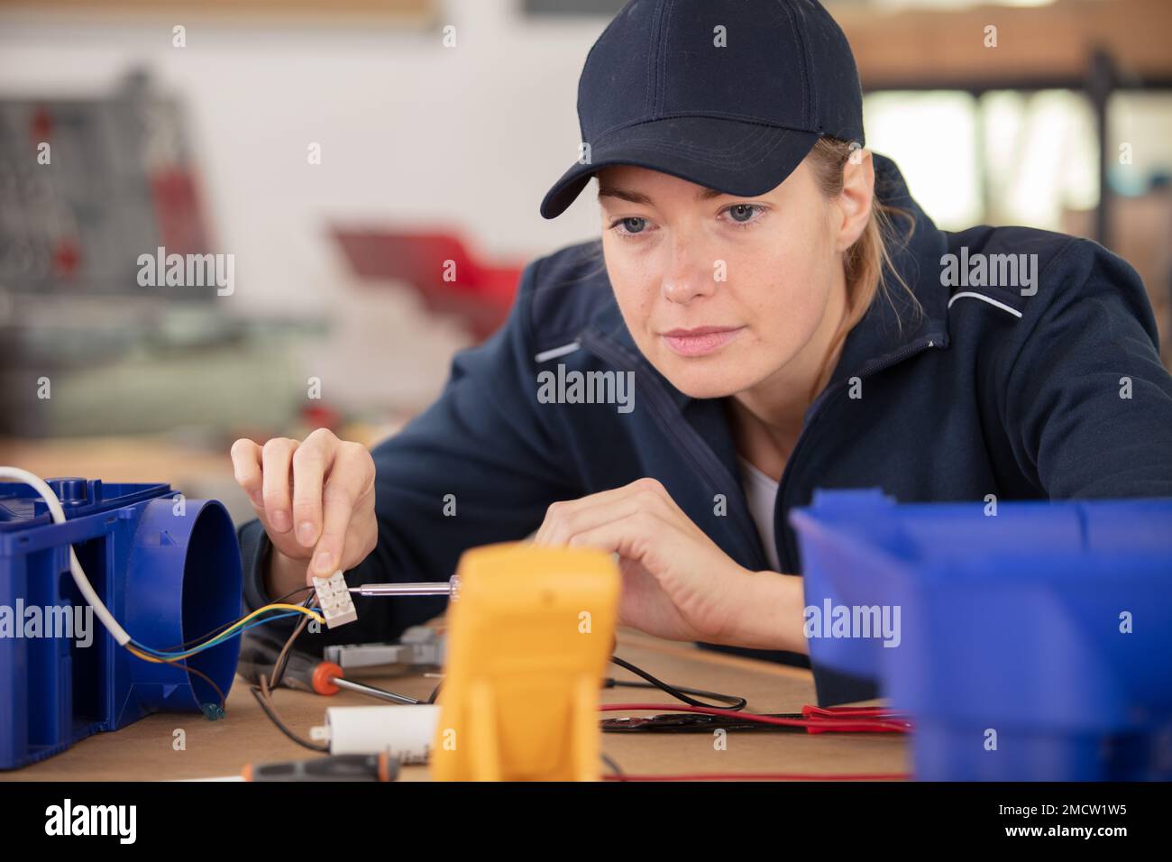 female technician wiring cables into chocolate box Stock Photo Alamy