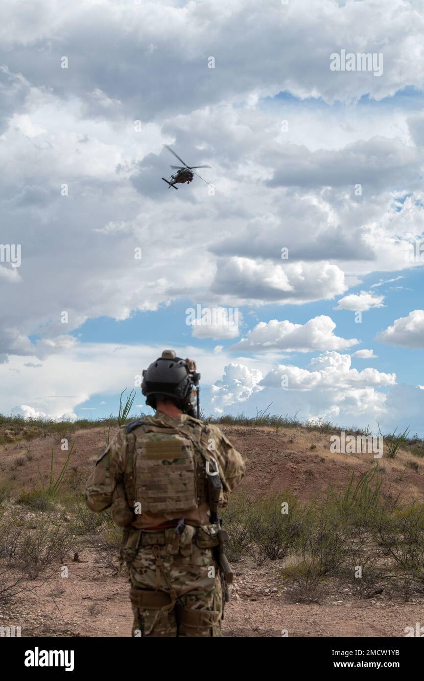 An Airman provides information to an HH-60G Pave Hawk helicopter regarding the situation on the ground in Arizona, June 9, 2022 during a training exercise. Ground and air teams work together to carry out rescue missions. Stock Photo