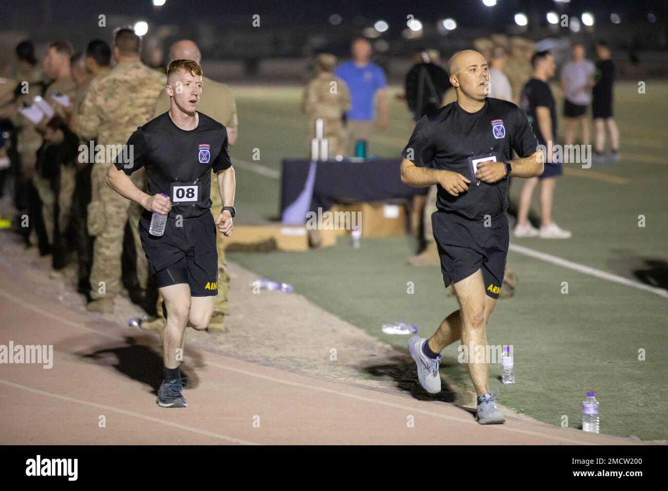 U.S. Soldiers run on a track during a physical fitness assessment at