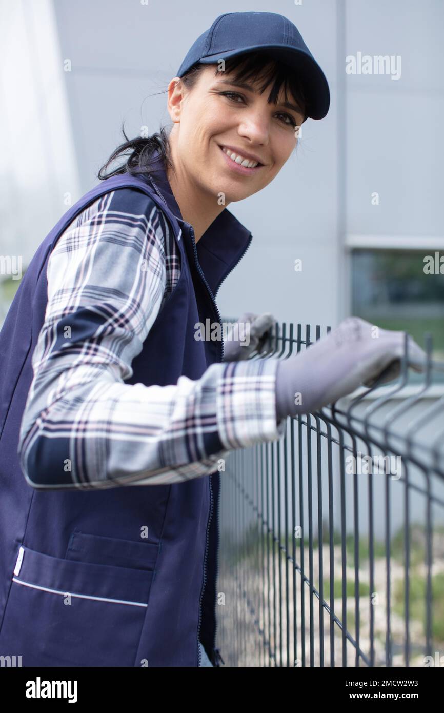 builder at construction site inspects a fence Stock Photo