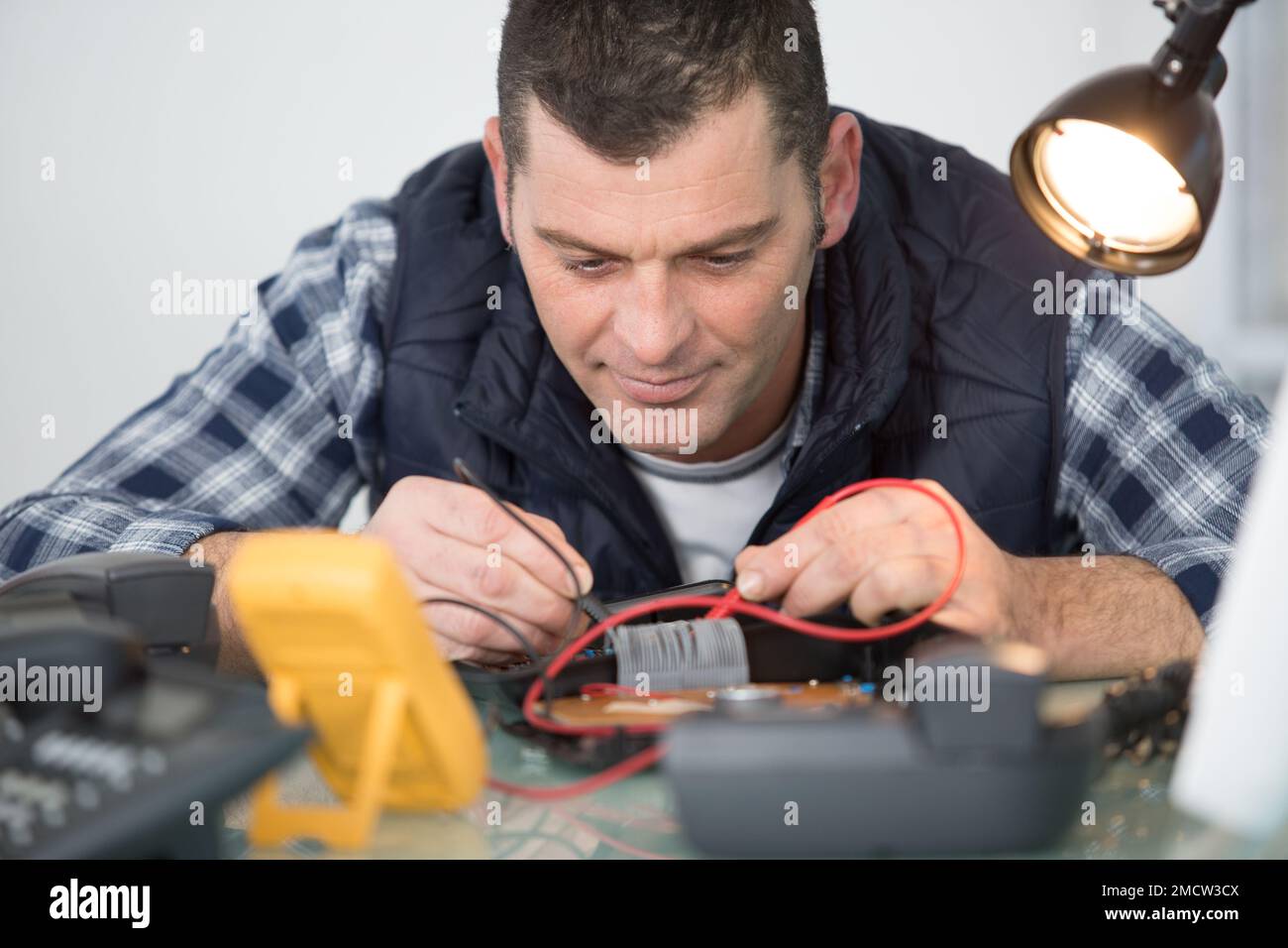 engineer using multimeter to test telephone handset Stock Photo Alamy