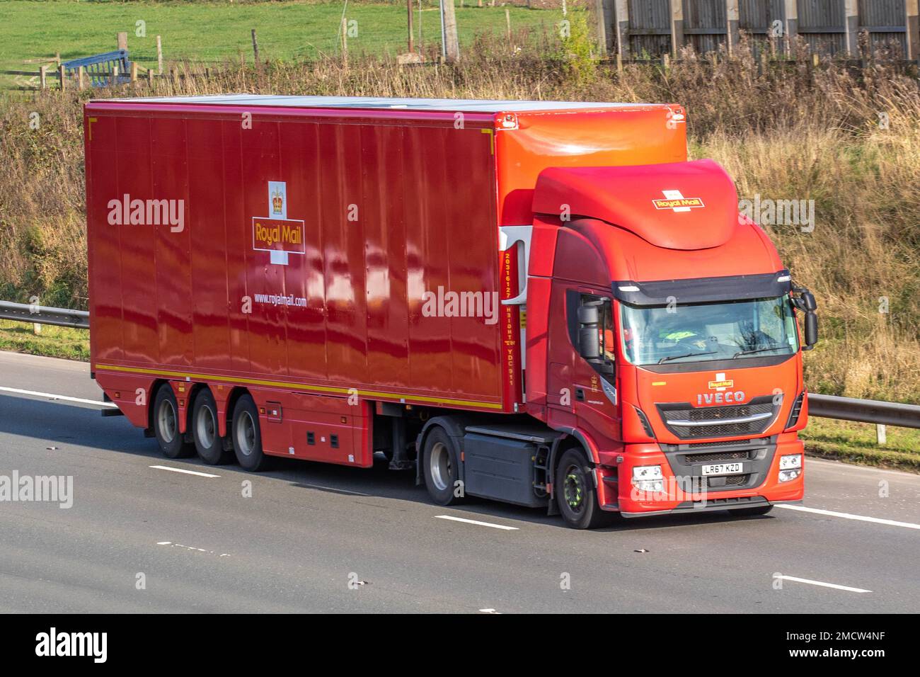 2018 Red Royal Mail IVECO 8710 Gas Rigid truck. Iveco Stralis NP 460 low-emission trucks travelling on the M6 Motorway UK Stock Photo