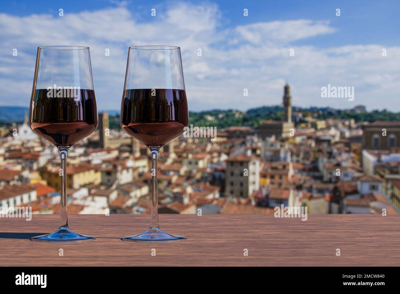 Two glass of red wine with view from above of Florence historic city
