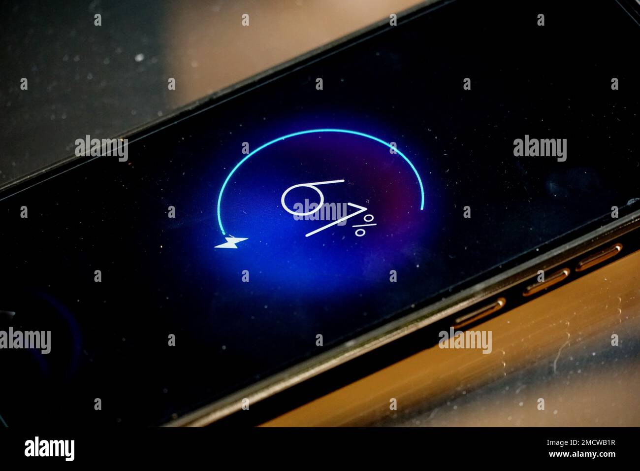 Close-up view of dirty smartphone charging Low battery level. Stock Photo