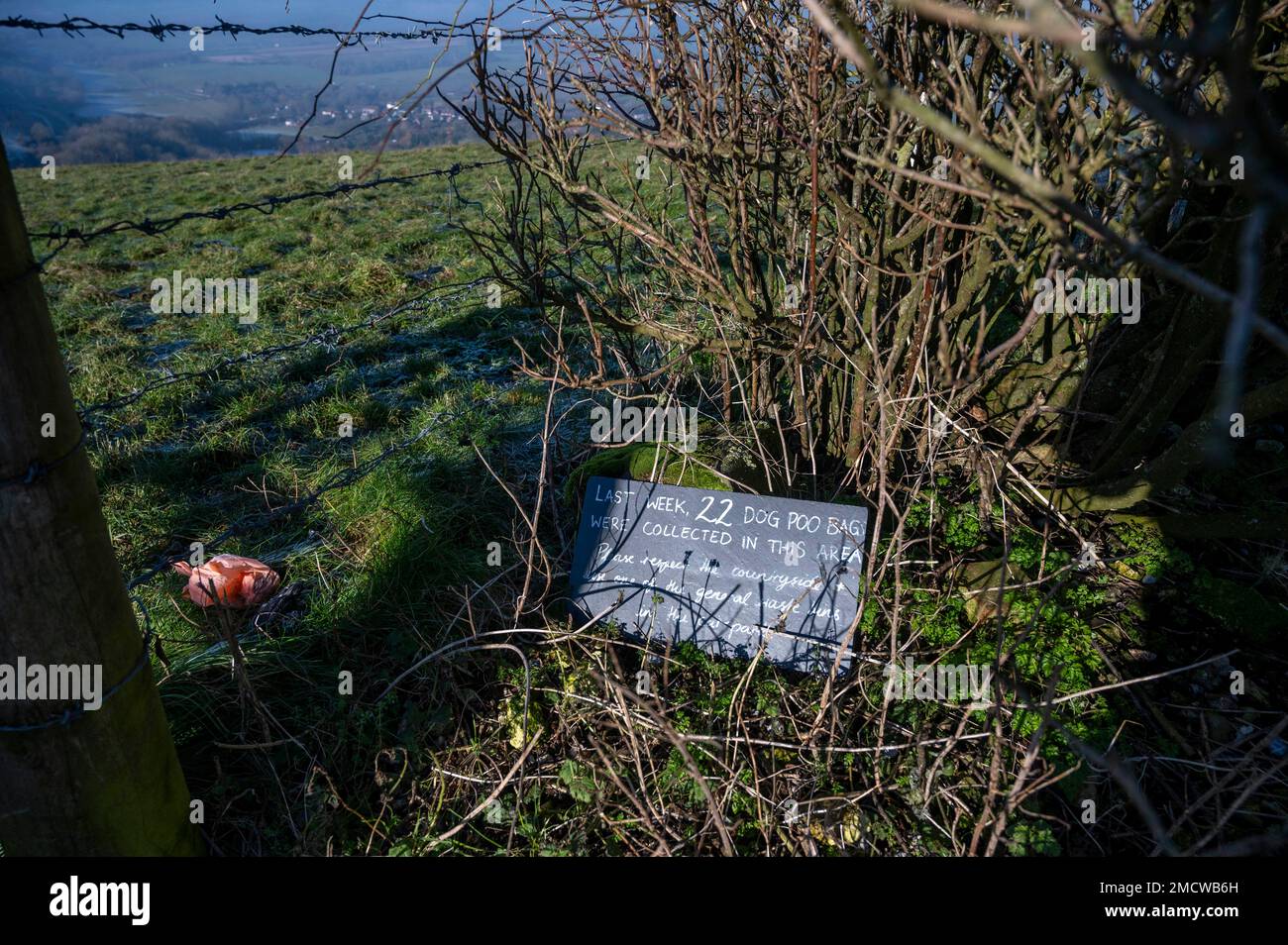 Brighton UK 22nd January 2023 - Dog walkers ignore a sign asking them not to leave dog poo bags at Devils Dyke along the South Downs Way near Brighton : Credit Simon Dack / Alamy Live News Stock Photo