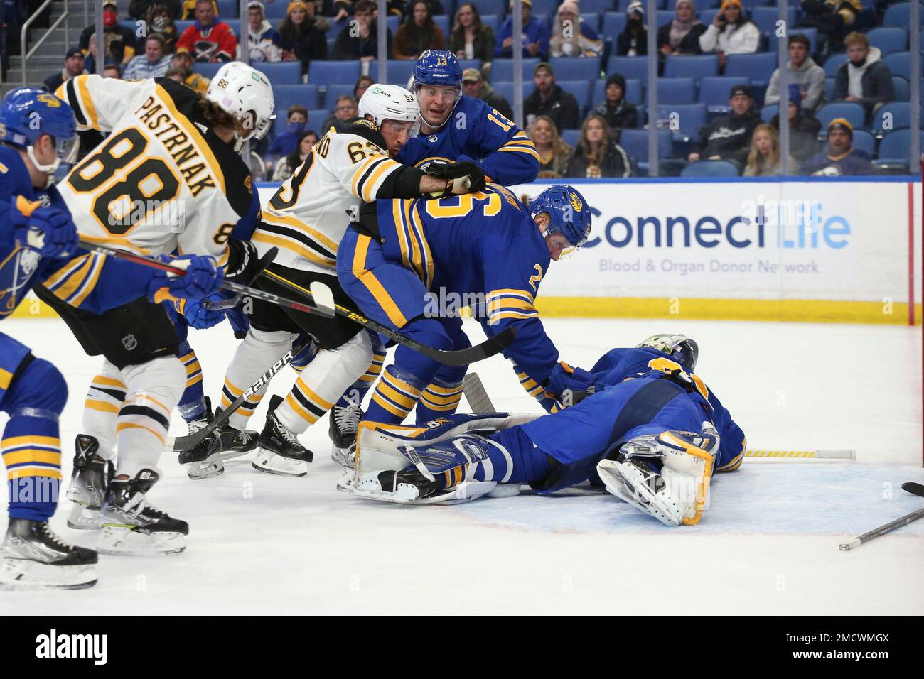 Boston Bruins' left wing Brad Marchand (63) collides with Buffalo Sabres'  defenseman Rasmus Dahlin (26) and defenseman Mark Pysyk (13) as he tries to  get the puck by goaltender Aaron Dell (80)