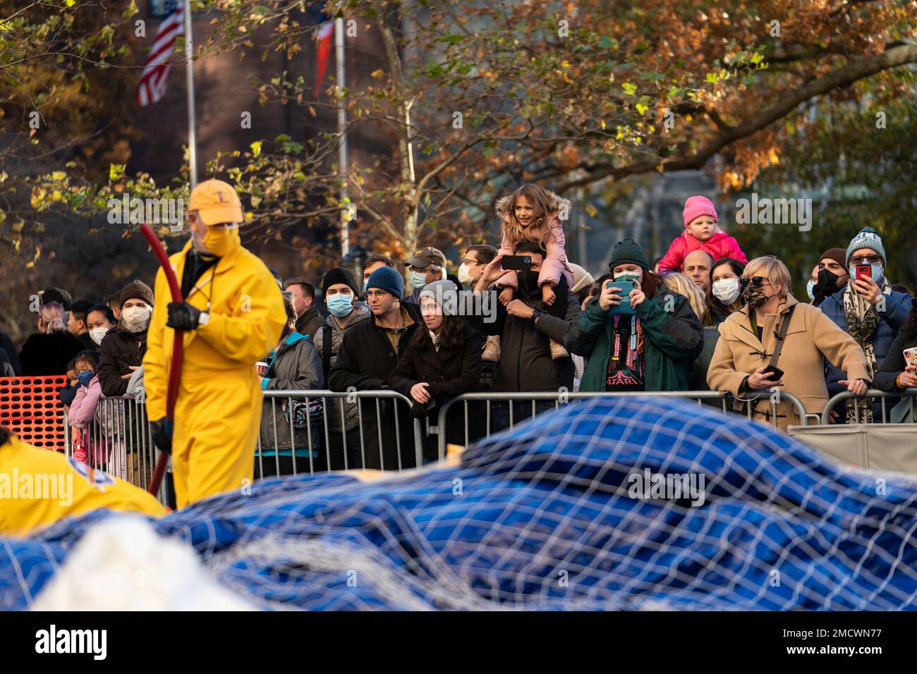 Spectators watch as inflation team members inflate balloons during Macy ...