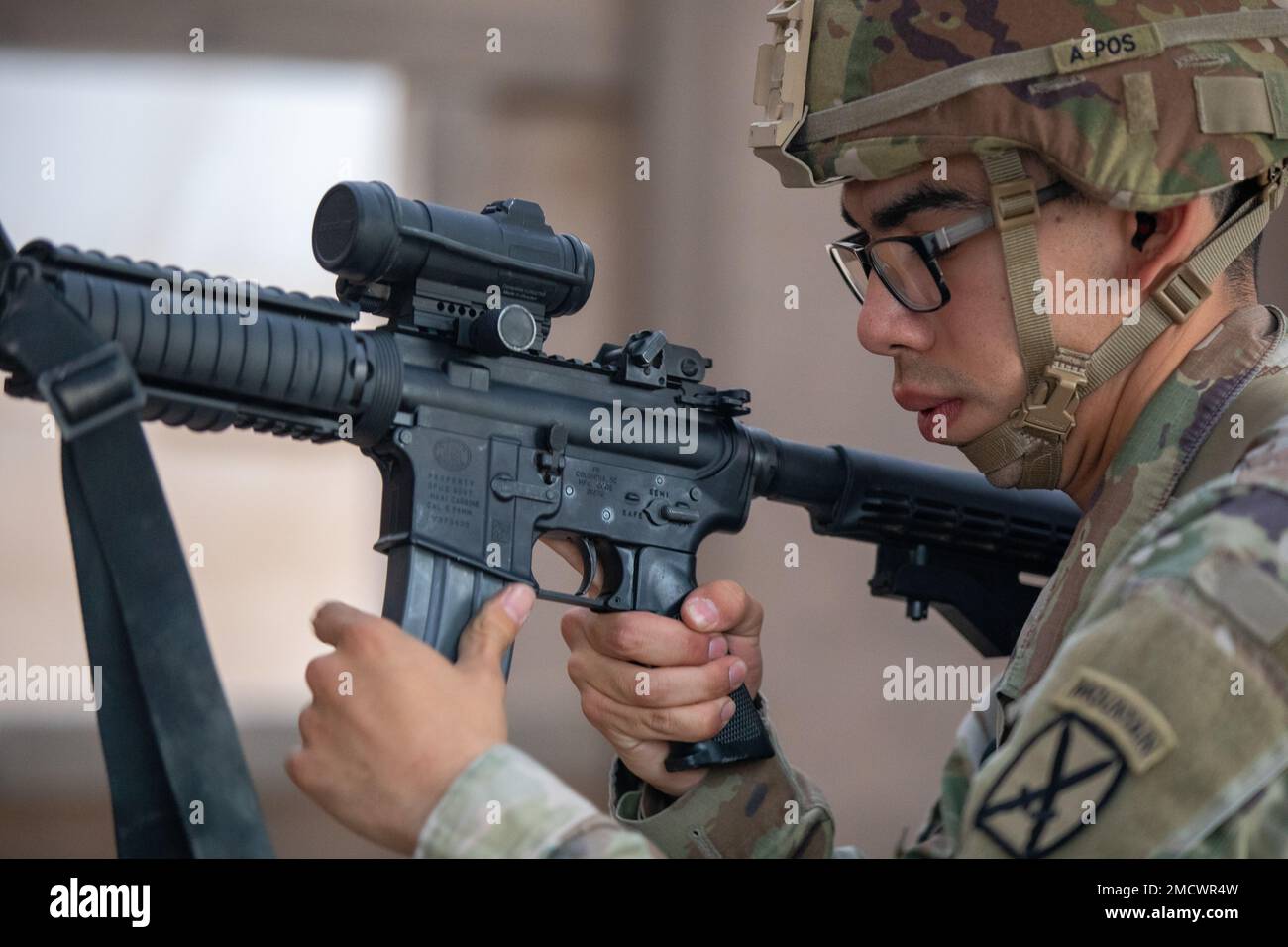 A U.S. Soldier with 10th Mountain Division loads an M4 carbine at Camp Buehring, Kuwait, July 10