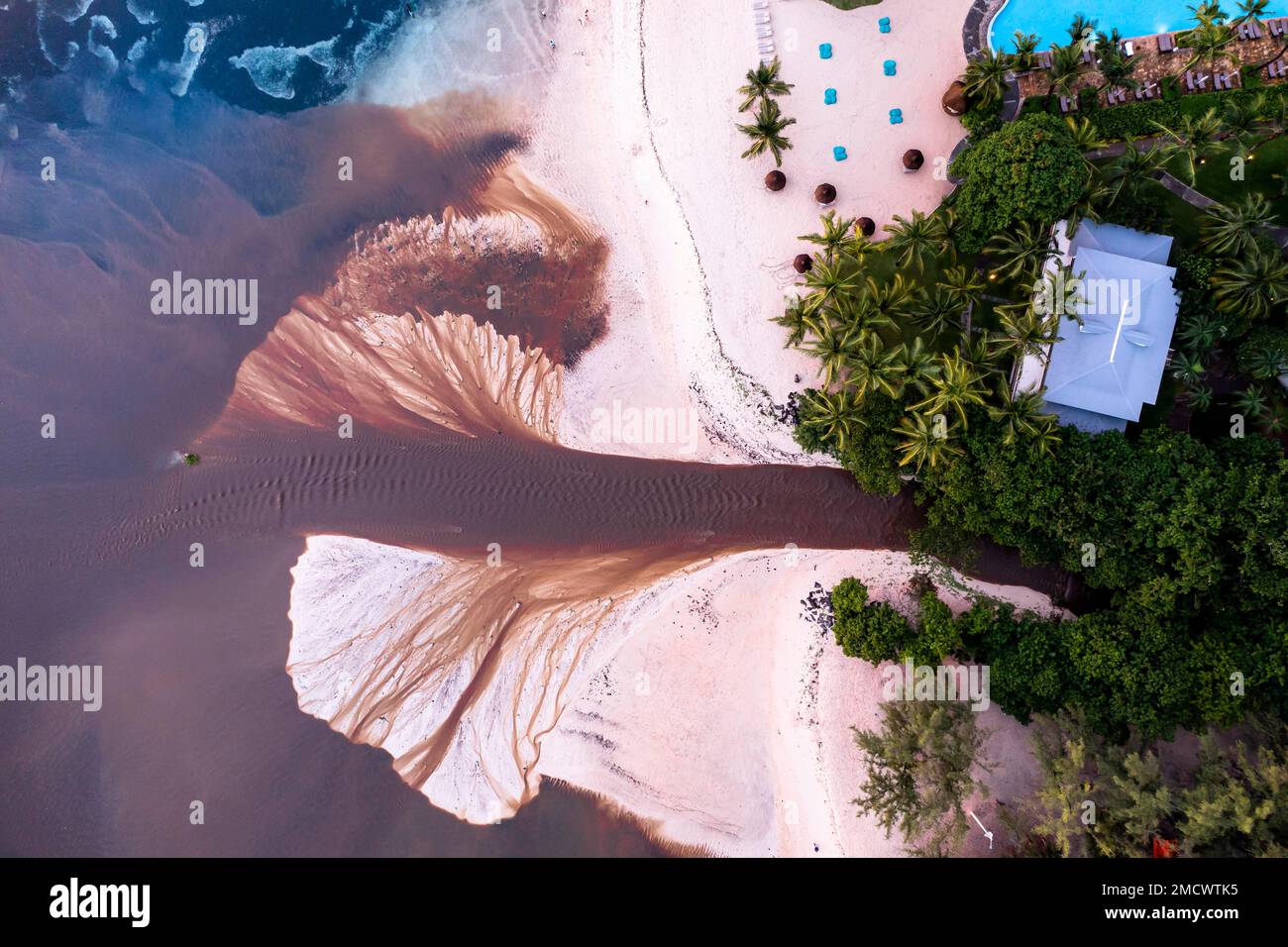 Aerial view, the coast of Flic en Flac, a river washes muddy water into