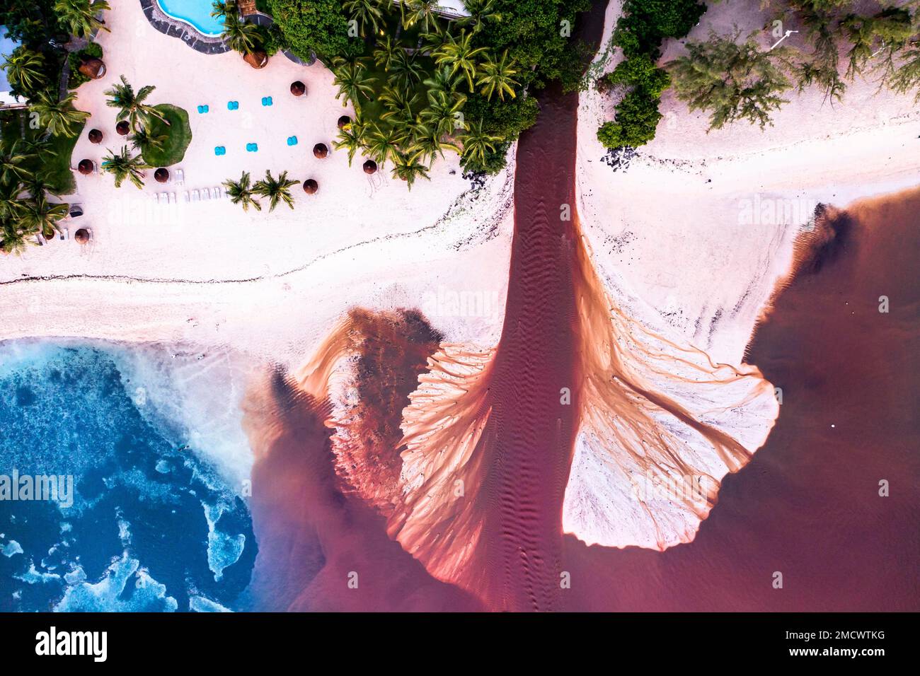 Aerial view, the coast of Flic en Flac, a river washes muddy water into