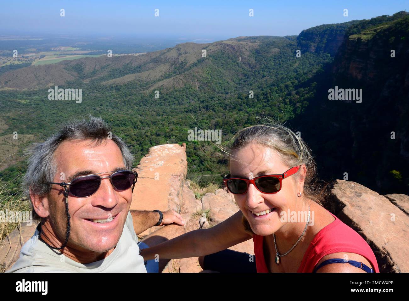 Older couple taking a photo of themselves at the Mirante Geodesico viewpoint, geographical centre of South America, Chapada dos Guimaraes NP, Mato Stock Photo