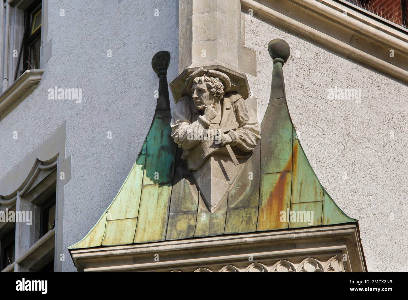Sculpture on house facade, stone figure of a master builder at ...