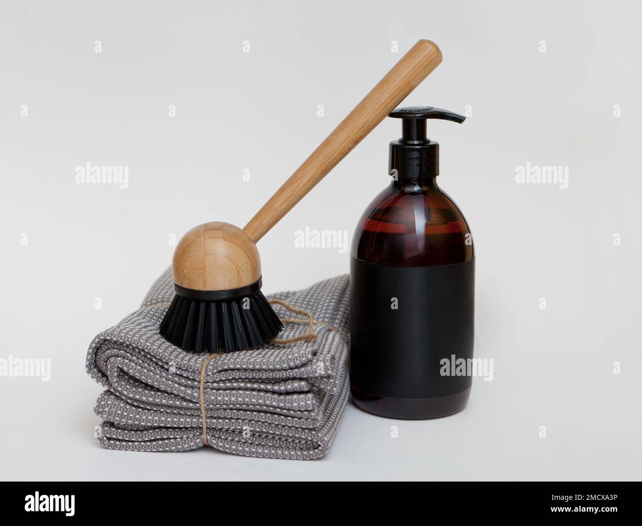 dish washing liquid. bamboo brush and towel. Zero waste kitchen cleaning, eco safe liquid soap jar Stock Photo