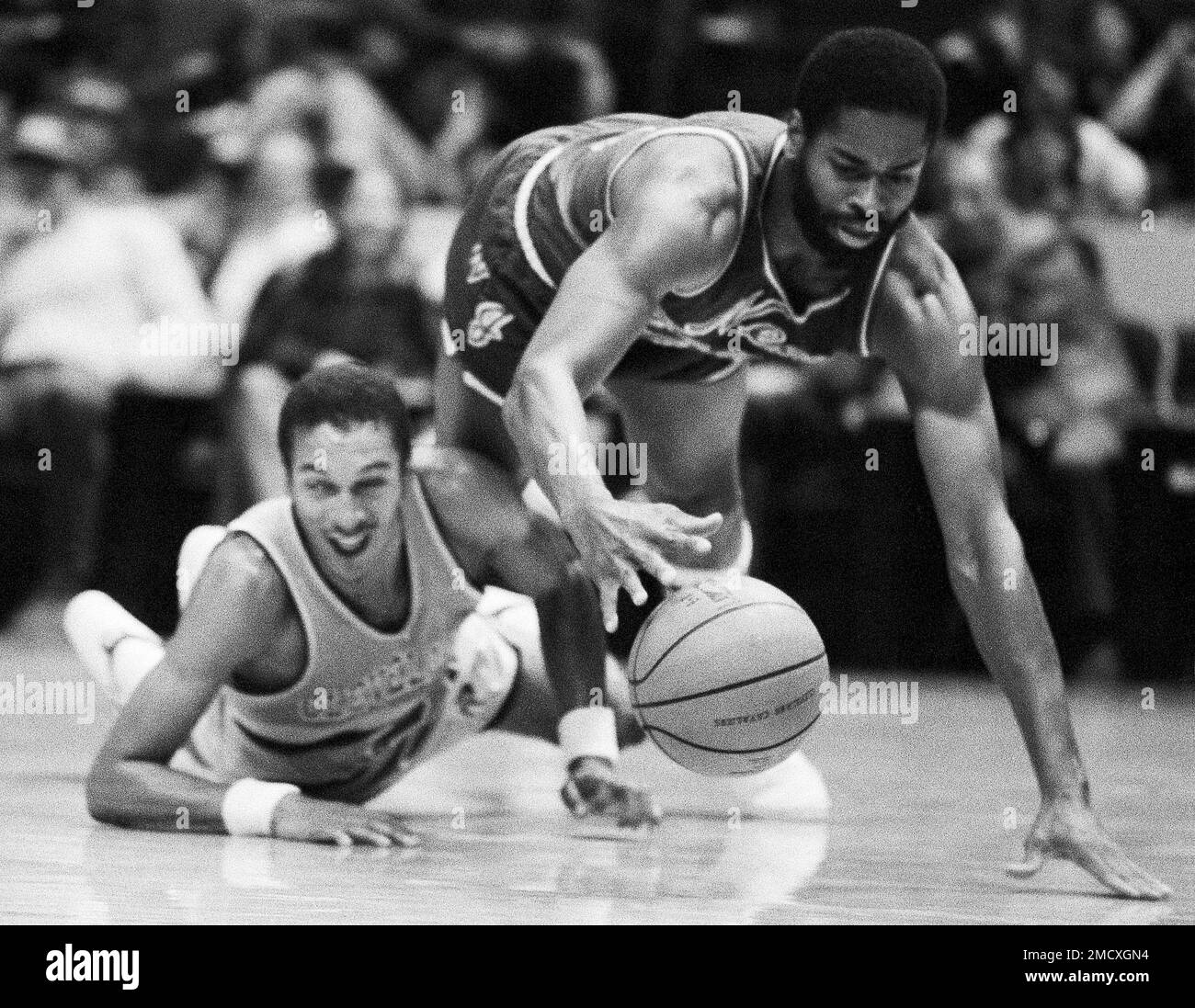 FILE - New Jersey Nets Len Elmore, right, trips over downed