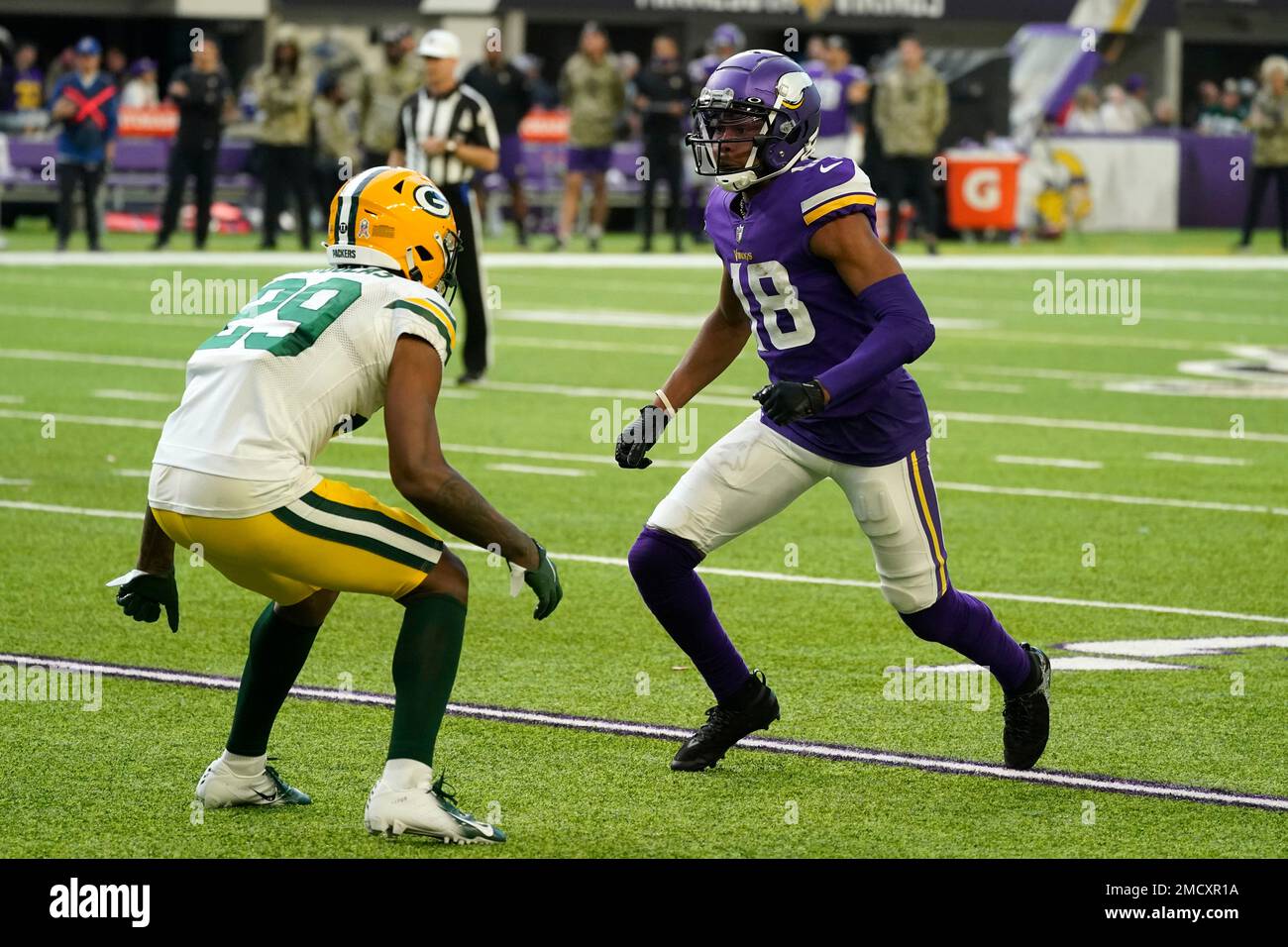Minnesota Vikings wide receiver Justin Jefferson (18) runs past Green