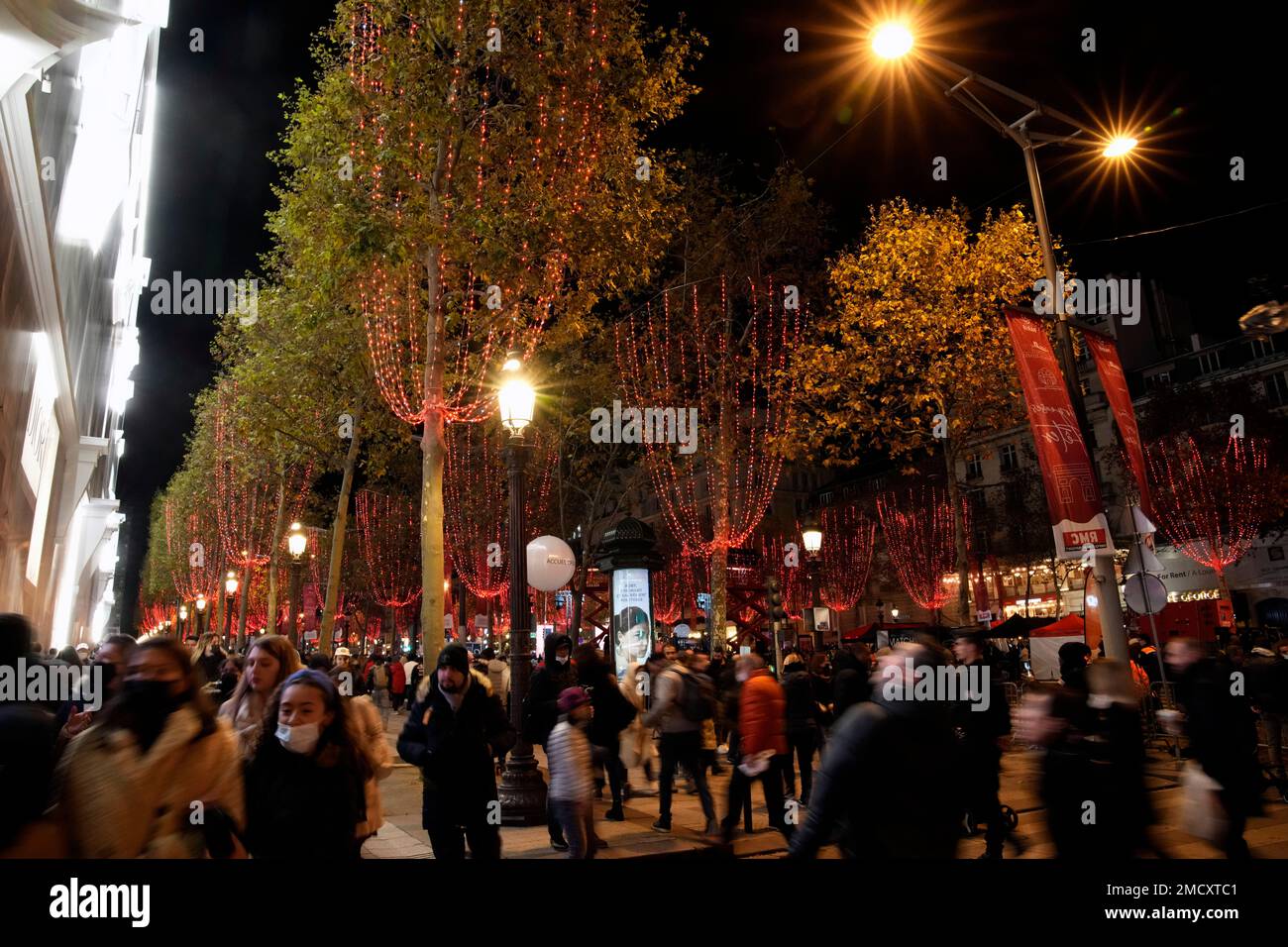 Spectators walks after attending the Champs Elysee Avenue illumination