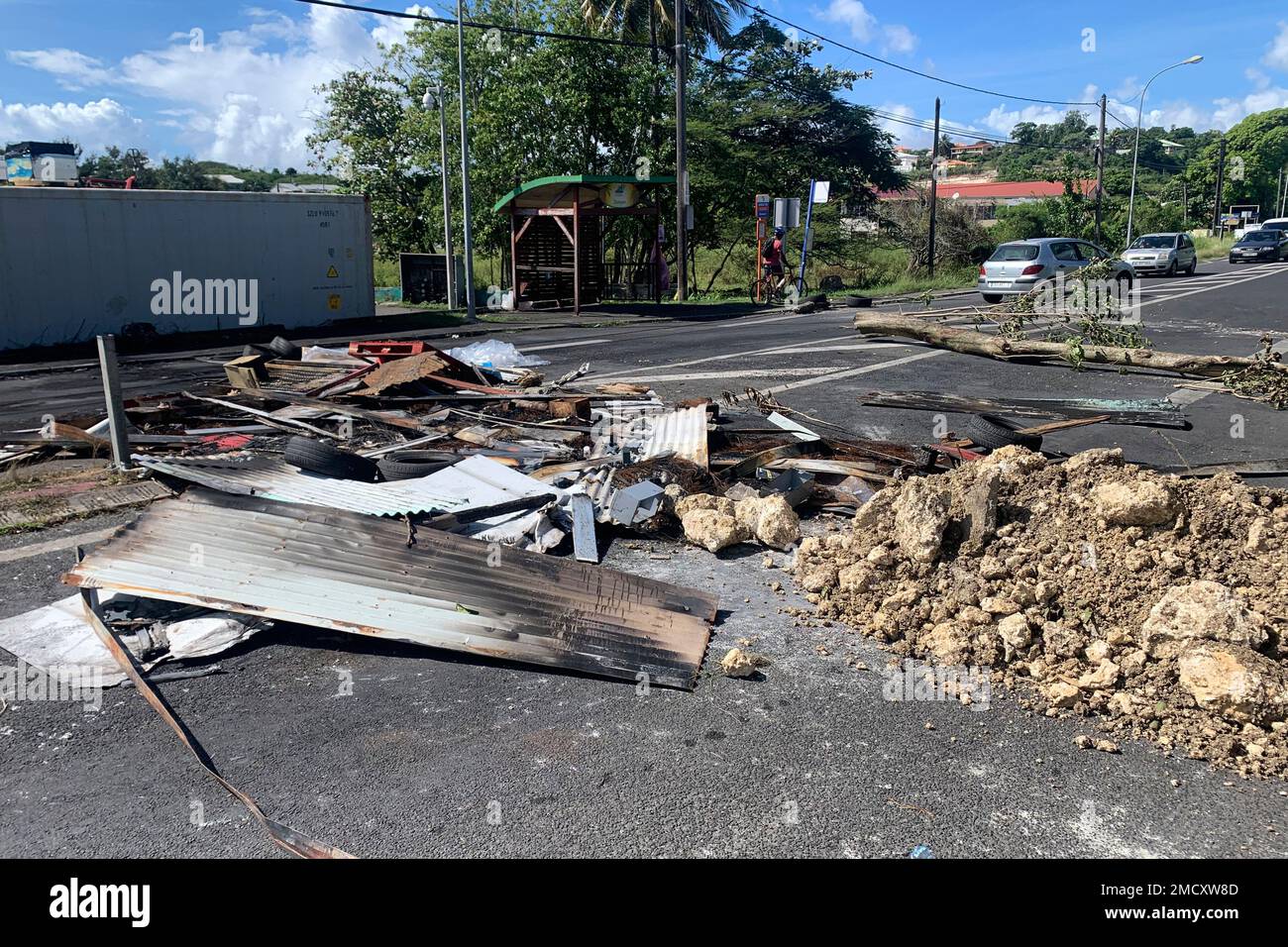 Debris left by demonstrators block a street of Le Gosier