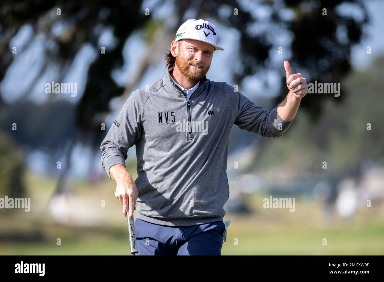 Tyler McCumber gives a thumbs-up to the crowd on the ninth hole after finishing 10-under par for the day during the final round of the RSM Classic golf tournament, Sunday, Nov