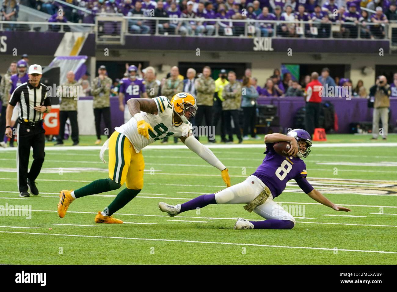 Minnesota Vikings quarterback Kirk Cousins (8) slides to the turf ahead of  Green Bay Packers outside linebacker Preston Smith (91) during the first  half of an NFL football game, Sunday, Nov. 21