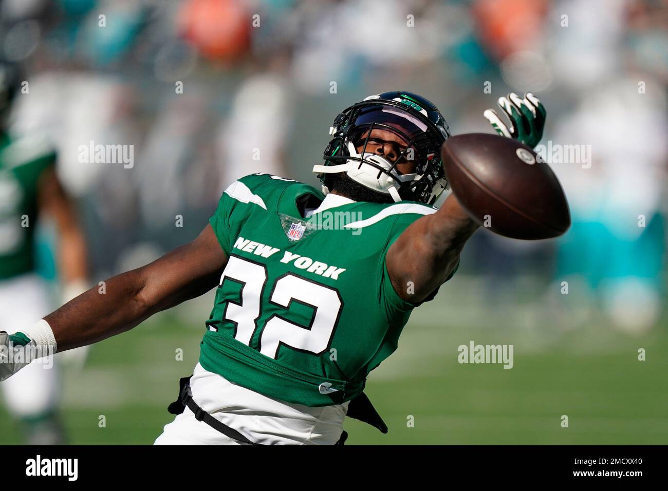 New York Jets running back Michael Carter (32) is tackled during the first  half of an NFL football game between the New York Jets and the Atlanta  Falcons at the Tottenham Hotspur