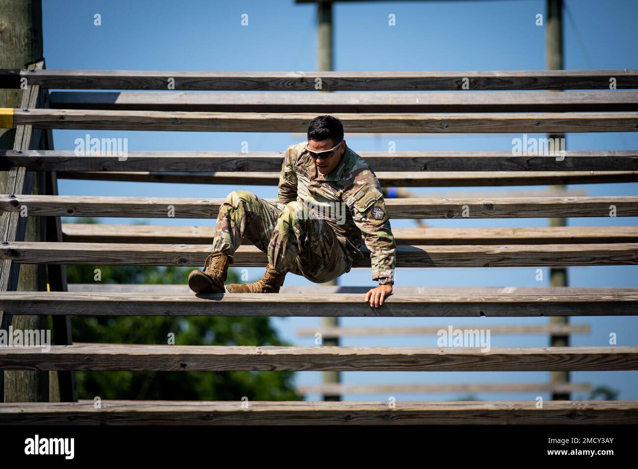 Cpt. John Linter, assigned with 48th Chemical Brigade, pictured while navigating an obstacle course in the Best Warrior and Best Squad Competition hosted by 20th Chemical, Biological, Radiological, Nuclear, and Explosives (CBRNE) Command at Fort Indiantown Gap, Pennsylvania, July 11, 2022. The 20th CBRNE Command’s Best Squad Competition and Best Warrior Competition is a single event used to select the best Noncommissioned Officer of the Year and Soldier of the Year from Soldiers within the command and its major subordinate commands. Stock Photo